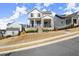 Two-story home with a covered front porch, nice landscaping, and a well-manicured lawn at 2005 Haley Walk, Woodstock, GA 30188