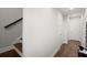Neutral hallway featuring hardwood floors, white walls, and access to multiple rooms at 2005 Haley Walk, Woodstock, GA 30188