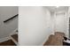 Bright hallway with stairs, wooden floor and white doors at 2005 Haley Walk, Woodstock, GA 30188