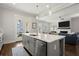 Open concept with a large kitchen island leading to the living room with a fireplace at 2005 Haley Walk, Woodstock, GA 30188