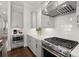 Close up on a kitchen with a stainless steel stove, vent hood and white subway tile backsplash at 2005 Haley Walk, Woodstock, GA 30188