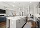 Open concept kitchen and living room featuring an island, stainless appliances, and hardwood floors at 2005 Haley Walk, Woodstock, GA 30188