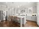 This spacious kitchen offers a large island, stainless steel appliances, and lovely hardwood floors at 2005 Haley Walk, Woodstock, GA 30188