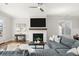 Stylish living room featuring a modern fireplace, and a large comfortable sectional sofa at 2005 Haley Walk, Woodstock, GA 30188