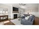 Bright and spacious living room with a brick fireplace, hardwood floors, and an open layout at 2005 Haley Walk, Woodstock, GA 30188