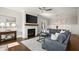 Inviting living room with hardwood floors, a stylish fireplace, and ample natural light at 2005 Haley Walk, Woodstock, GA 30188