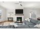 Bright living room featuring hardwood floors, a fireplace, and comfortable, oversized seating at 2005 Haley Walk, Woodstock, GA 30188