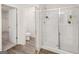Modern bathroom featuring a glass shower with shelving, and a toilet in a separate room at 216 Eping Dr, Stockbridge, GA 30281