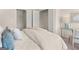 Bright bedroom with plush bedding, a glass desk, and closet with white folding doors at 216 Eping Dr, Stockbridge, GA 30281
