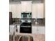 Modern kitchen with granite counters, stainless steel appliances, and gray subway tile backsplash at 216 Eping Dr, Stockbridge, GA 30281