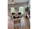 Bright living room with wood floors, large windows, a ceiling fan and stylish furnishings at 216 Eping Dr, Stockbridge, GA 30281