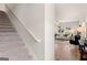 Carpeted staircase leading to an open-concept living room with hardwood floors at 216 Eping Dr, Stockbridge, GA 30281