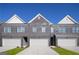 New construction townhomes with brick facades, two-car garages, and manicured front lawns at 216 Eping Dr, Stockbridge, GA 30281