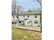 Expansive backyard featuring a large deck with room for seating and mature trees at 313 Summit Ridge Dr, Lawrenceville, GA 30046