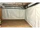 Finished basement featuring insulated walls, wood-look floors, and exposed ceiling beams at 313 Summit Ridge Dr, Lawrenceville, GA 30046
