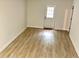 Finished basement with wood-look flooring, white-painted walls, and a bright exterior door at 313 Summit Ridge Dr, Lawrenceville, GA 30046