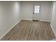 Finished basement featuring wood-look flooring and white-painted walls at 313 Summit Ridge Dr, Lawrenceville, GA 30046