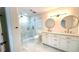 Elegant bathroom featuring double vanity with marble countertop and a sleek glass-enclosed shower at 313 Summit Ridge Dr, Lawrenceville, GA 30046