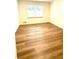 Bedroom featuring hardwood floors and a large window at 313 Summit Ridge Dr, Lawrenceville, GA 30046