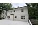 This home's exterior is freshly painted white with black trim, providing a modern and appealing look at 313 Summit Ridge Dr, Lawrenceville, GA 30046