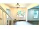 Bright foyer features wood floors, a modern light fixture, and a charming glass paneled entry door at 313 Summit Ridge Dr, Lawrenceville, GA 30046