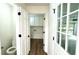 Hallway view of half bath and laundry room, looking towards the garage at 313 Summit Ridge Dr, Lawrenceville, GA 30046
