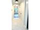 Hallway with white marble floors leads to a well-lit area, creating a clean and open feel at 313 Summit Ridge Dr, Lawrenceville, GA 30046