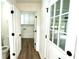 Hallway view of laundry room and half bath, looking towards the garage at 313 Summit Ridge Dr, Lawrenceville, GA 30046