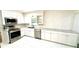 Modern white kitchen with stainless steel appliances, granite countertops, and subway tile backsplash at 313 Summit Ridge Dr, Lawrenceville, GA 30046