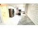Open kitchen featuring stainless steel appliances, white cabinets and white marble floors at 313 Summit Ridge Dr, Lawrenceville, GA 30046