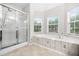 Bright bathroom featuring large windows, soaking tub, and glass enclosed shower at 3492 Newtons Crest Cir, Snellville, GA 30078