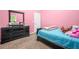 Pink bedroom with dresser, bed and natural light from the window at 3492 Newtons Crest Cir, Snellville, GA 30078