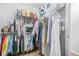 Walk in closet with shelves and hanging clothes and personal items on shelves at 3492 Newtons Crest Cir, Snellville, GA 30078