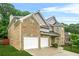 Charming two-story brick home with attached two-car garage and well-manicured lawn at 3492 Newtons Crest Cir, Snellville, GA 30078