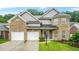 Charming two-story brick home with attached two-car garage and well-manicured lawn at 3492 Newtons Crest Cir, Snellville, GA 30078