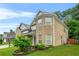 Lovely two-story brick home features a manicured lawn and side yard landscaping at 3492 Newtons Crest Cir, Snellville, GA 30078