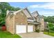Charming two-story brick home with attached two-car garage and well-manicured lawn at 3492 Newtons Crest Cir, Snellville, GA 30078