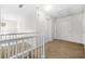 Second-floor hallway featuring neutral carpet and white railing at 3492 Newtons Crest Cir, Snellville, GA 30078