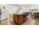 Open kitchen island with breakfast bar next to a staircase and entryway at 3492 Newtons Crest Cir, Snellville, GA 30078