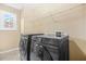 Well-equipped laundry room boasts new machines and built-in shelving for optimal organization at 3492 Newtons Crest Cir, Snellville, GA 30078