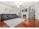 Comfortable living room offers a fireplace, built-in shelves, and hardwood floors at 3492 Newtons Crest Cir, Snellville, GA 30078