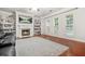 Cozy living room with fireplace, built-in bookshelves, and hardwood floors at 3492 Newtons Crest Cir, Snellville, GA 30078
