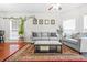 Comfortable living room with hardwood floors, a ceiling fan, and two sofas at 3492 Newtons Crest Cir, Snellville, GA 30078