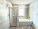 The bright bathroom has a glass enclosed shower and soaking tub at 3655 Peachtree Ne Rd # 304, Atlanta, GA 30319