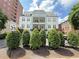 Beautiful condominium building with well-manicured landscaping and an American flag at 3655 Peachtree Ne Rd # 304, Atlanta, GA 30319