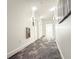 A carpeted hallway with neutral walls, sconce lighting, and a fire extinguisher at 3655 Peachtree Ne Rd # 304, Atlanta, GA 30319