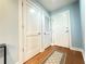 Hallway view highlighting the hardwood floors and a trio of doors at 3655 Peachtree Ne Rd # 304, Atlanta, GA 30319