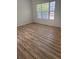 This large bedroom has hardwood floors and a large window to allow for plenty of natural light at 4540 Cold Spring Ct, Cumming, GA 30041