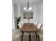Modern dining room with hardwood floors, decorative lighting, and plenty of natural light at 4540 Cold Spring Ct, Cumming, GA 30041