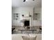 Open-concept living room showcasing a fireplace and built-in shelving at 4540 Cold Spring Ct, Cumming, GA 30041